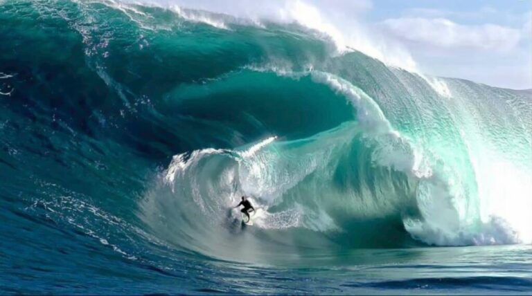 A surfer riding a wave, symbolizing the concept of going with the flow.